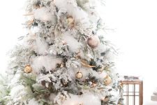 23 an enchanting Christmas tree with gold and copper ornaments, natlers, white faux fur garlands, antlers and pinecones is veyr glam-like