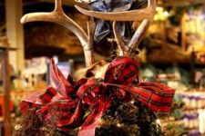 24 a leather star paired with antlers and a red plaid ribbon bow is a fantastic Christmas tree topper for a woodland-inspired space