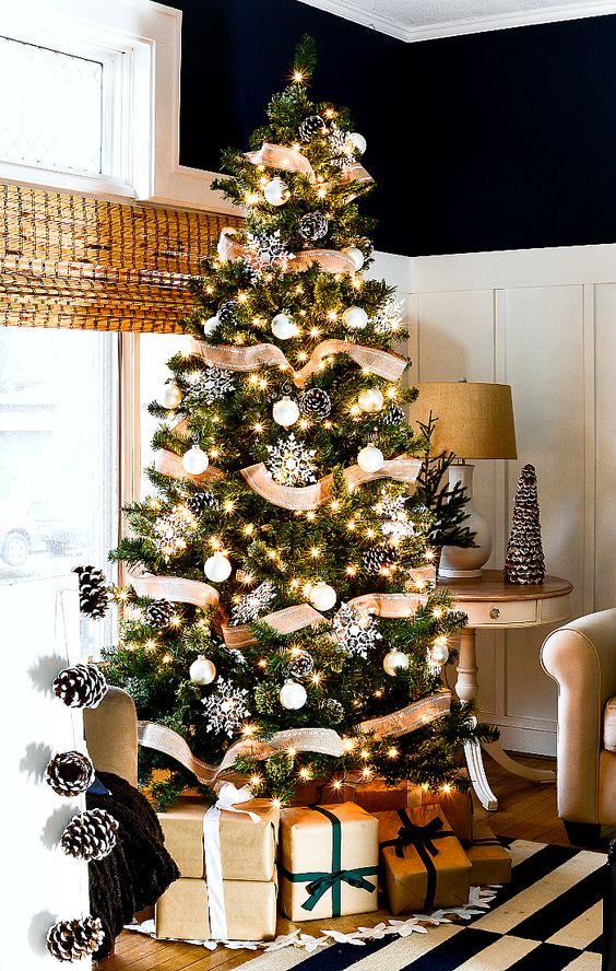 lovely rustic Christmas tree decor with burlap ribbons, snowy pinecones, white ornaments and snowflakes is chic