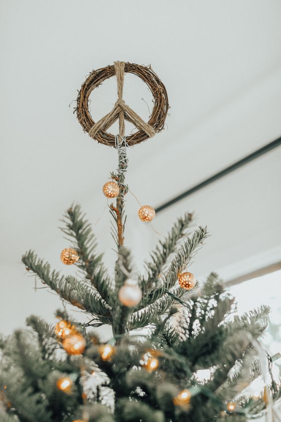 a peace sign made of vine is a perfect Christmas tree topper for a boho space, it looks unusual, fresh and matches the style perfectly