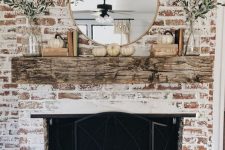 25 a rustic and shabby chic whitewashed brick fireplace with a weathered wood mantel, a beautiful metal screen, greenery and pumpkins for the fall
