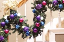 25 a staircase garland with blue, purple and fuchsia ornaments and large neutral bows and lights is amazing for a bright touch