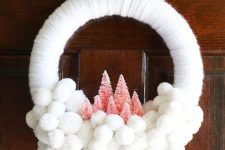 25 a white yarn and pompom Christmas wreath with pink bottle brush trees is a soft and lovely decor idea for a neutral space