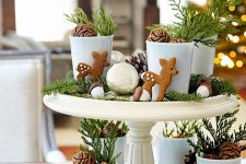 27 a pretty forest-themed Christmas centerpiece of pinecones, evergreens, little metallic baubles, deer cookies and acorns