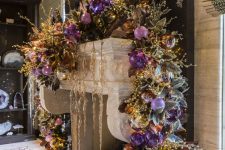 27 a super lush and refined garland with lilac, purple, silver and gold ornaents, beads and lights is a gorgeous way to dress up a mantel