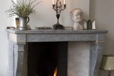 27 a vintage fireplace with a grey stone mantel over it and a brick baffle is a gorgeous centerpiece for your space