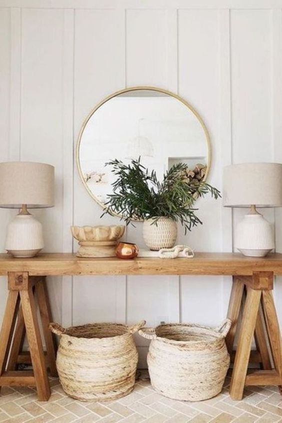 a farmhouse console table and baskets for storage is a cool idea for a farmhouse entryway or living room