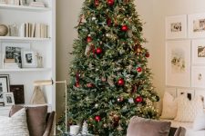 30 a beautiful Christmas tree with gold, red and dark green ornaments and lights is a fresh take on the traditional color scheme