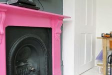 30 a vintage black metal fireplace and a hot pink mantel over it is a bold and chic touch of color with a playful feel