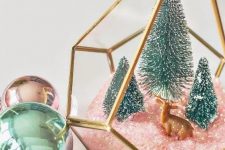 30 an elegant Christmas terrarium with pink faux snow, green bottle brush trees and a little deer figurine is chic and cute