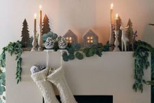 30 beautiful woodland Christmas decor with snowy pinecones, greenery and evergreens, plywood Christmas trees, candles, firewood with lights and mercury glass ornaments
