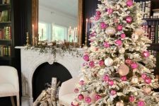31 a sophisticated flocked Christmas tree decorated with white, blush and pink ornaments and lights and a lit up star topper