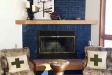 34 a modern space wiht a navy brick fireplace, a boho rug, a metal sid etable and upholstered chairs with faux fur