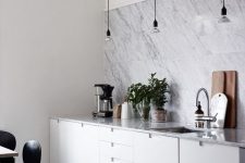 34 a modern white kitchen with a white marble tile backsplash and countertops looks chic, elegant and stylish