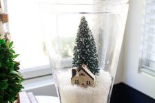 34 a pretty Christmas snow globe with faux snow, a cardboard house and a bottle brush tree is a lovely idea