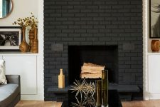 35 a chic modern space with a black brick fireplace, elegant furniture, a glossy black coffee table with gold decor