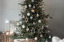 35 a modern and chic Christmas tree with white, grey and sheer ornaments, plywood stars, houses and lights is amazing
