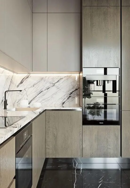 an elegant modern two-toned kitchen with a black and white marble backsplash and countertop for a refined feel