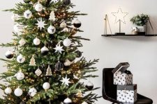 42 a beautiful modern Christmas tree with lights, black, white and stained plywood ornaments is a very chic idea suitable for a Nordic space