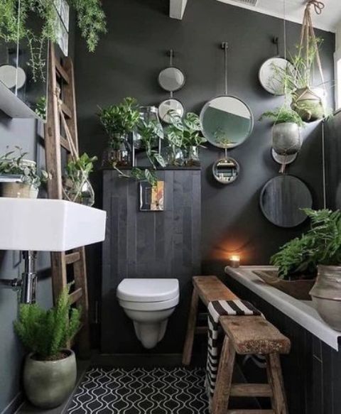 a biophilic moody bathroom with lots of plants in pots hanging and standing everywhere is a great idea to rock