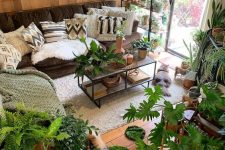 44 a beautiful biophilic living room with lots of potted plants all over looks like a whole jungle and invites in