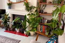 46 a beautiful biophilic living room with lots of statement potted plants here and there including the non-working fireplace