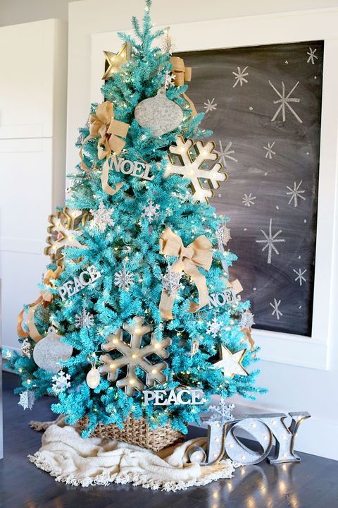 a fabulous turquoise Christmas tree with lights, marquee snowflakes, letter decor, burlap bows and a basket to hide the base