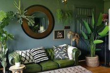 48 a bold and catchy living room with lots of potted plants standing and hanging around and with jungle-themed prints
