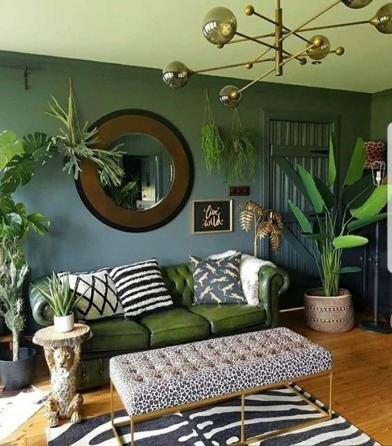 a bold and catchy living room with lots of potted plants standing and hanging around and with jungle-themed prints