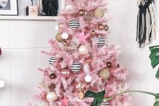 49 a glam pink Christmas tree with white, gold, gold glitter and striped ornaments plus a star on top is a very pretty and stylish idea