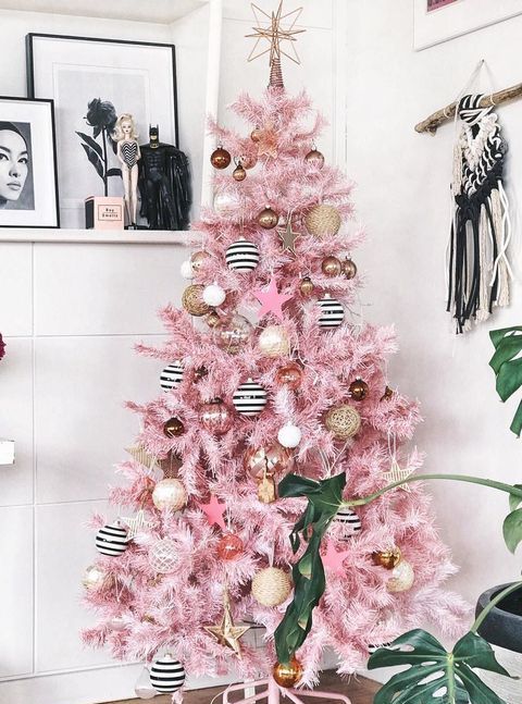 a glam pink Christmas tree with white, gold, gold glitter and striped ornaments plus a star on top is a very pretty and stylish idea