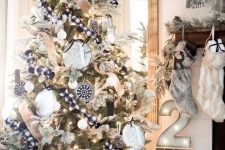 a bold black and white rustic Christmas tree decorated with buffalo check and burlap ribbons, black and white ornaments, lights, an oversized black plywood star topper is amazing