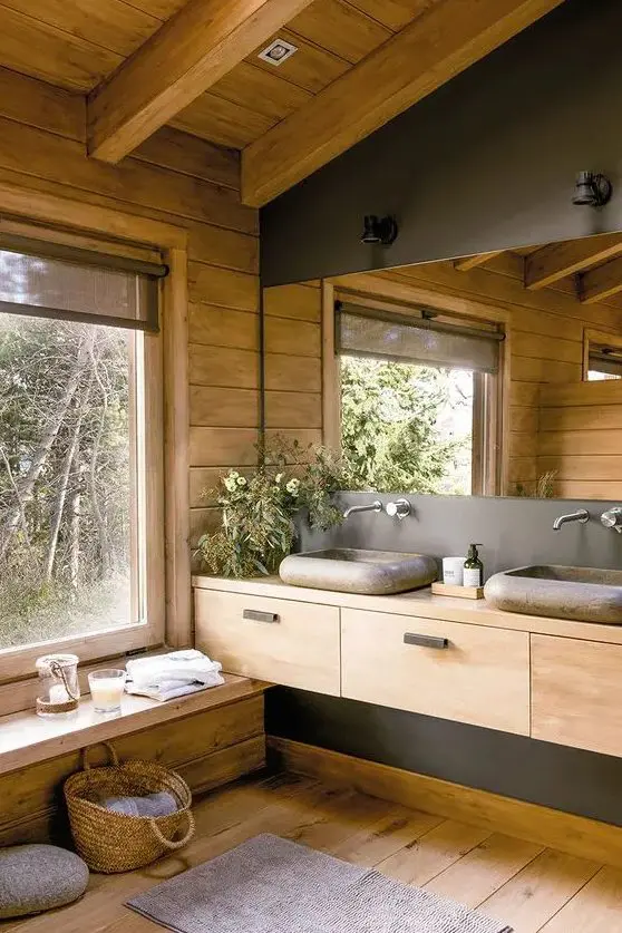 a contemporary bathroom fully clad with wood, with a large mirror, a wooden vanity and a window for a cool view