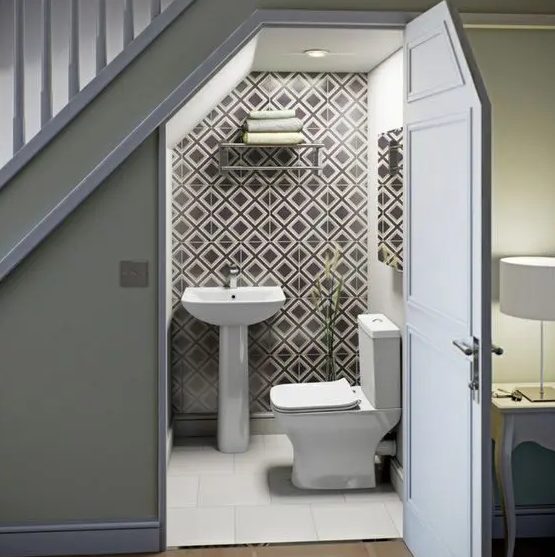 a contemporary powder room done with geometric tiles, a pedestal sink, a wall-mounted shelf for storage