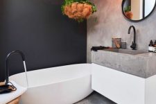 a stylish bathroom with a black accent wall