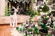 a crazy Christmas tree with buffalo check, green, white, metallic ornaments and ribbons, lights and gift boxes