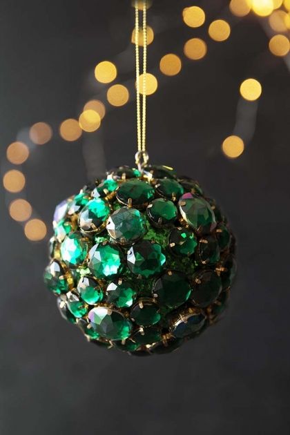 a fantastic Christmas ornament fully covered with oversized green rhinestones is a glam decor idea to realize yourself