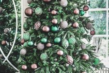 a green Christmas tree with brown and green ornaments and leaves on top is cool for the holidays