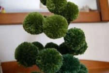 a green pompom swirl Christmas tree with a yellow star topper is a lovely and easy decoration for the holidays