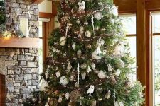 a luxurious woodland Christmas tree with white, silver and brown ornaments, owls, vine balls and garlands and icicles