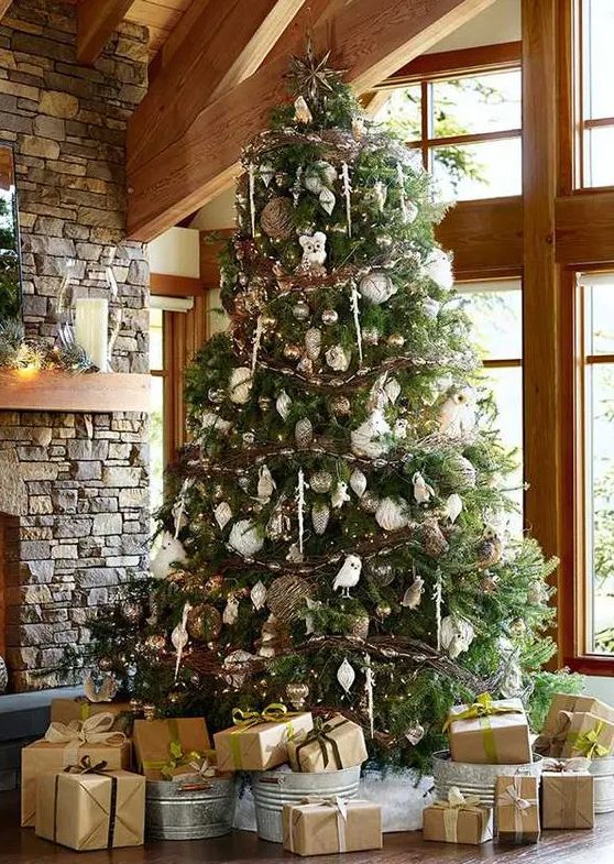 a luxurious woodland Christmas tree with white, silver and brown ornaments, owls, vine balls and garlands and icicles