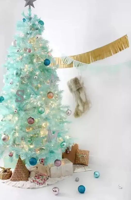 a modern mint green Christmas tree with colorful ornaments, a monogram and lights is a lovely and cool idea