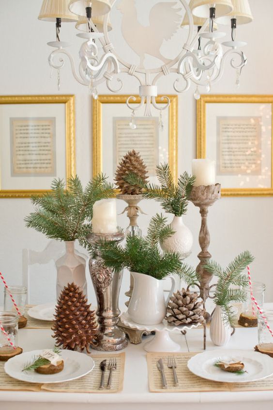a natural Christmas tablescape with vintage jugs and candleholders, pinecones and evergreens is very cozy