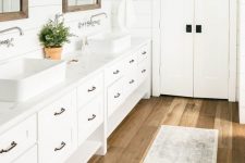 a cozy farmhouse bathroom design with wood flooring