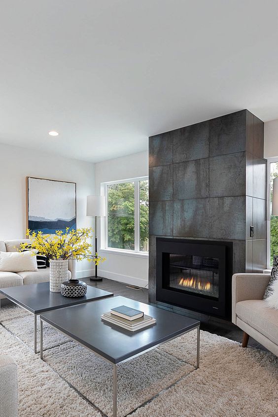 a neutral living room design with a metal fireplace
