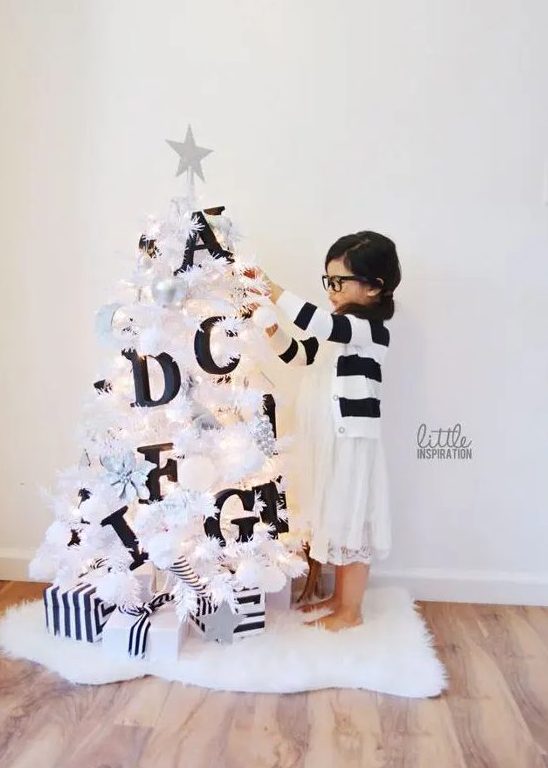 a small white Christmas tree decorated with black letters will help your kids learn them - make such a space for your kids' room