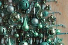a wall Christmas tree composed of green ornaments of various sizes, stars and jingle bells plus bead garlands is a very creative idea