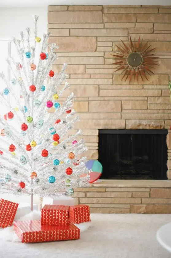 a white Christmas tree with lots of colorful Christmas ornaments looks pretty, chic and vintage