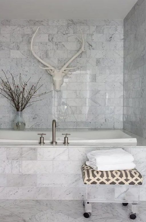 a white marble bathroom done with tiles - an amazing idea to use if you aren't ready to splurge on real marble