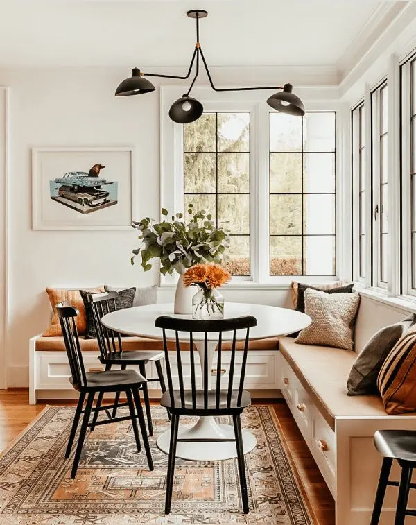 a cozy breakfast space with a banquette seating